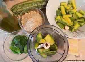 ingredients of zucchini pesto like zucchini, almond, evoo, garlic and basil leaves