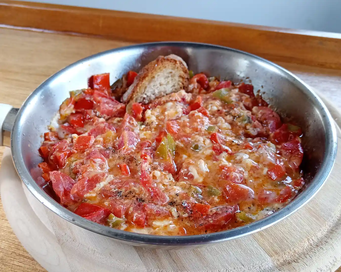 Menemen, ricco di colori e nutrienti è servito in una padella con una fetta di pane tostato